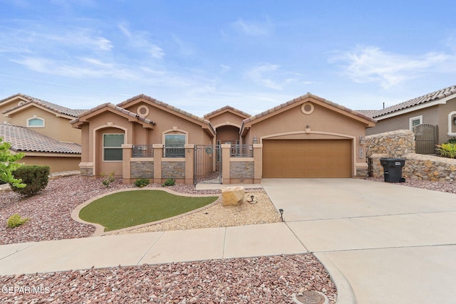 737 Colonial Blf, El Paso, TX 79928 - mediterranean / spanish-style house with a gate, stucco siding, concrete driveway, an attached garage, and a tile roof
