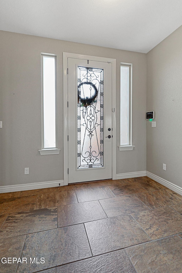 737 Colonial Blf, El Paso, TX 79928 - entrance foyer with baseboards and stone finish floors