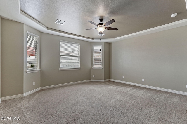 737 Colonial Blf, El Paso, TX 79928 - unfurnished room with a textured ceiling, a raised ceiling, ceiling fan, carpet floors, and baseboards