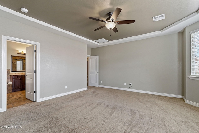 737 Colonial Blf, El Paso, TX 79928 - unfurnished bedroom featuring carpet, a raised ceiling, baseboards, connected bathroom, and a ceiling fan