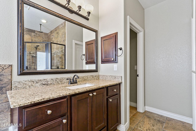 737 Colonial Blf, El Paso, TX 79928 - bathroom with baseboards, a stall shower, and vanity