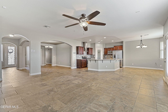 737 Colonial Blf, El Paso, TX 79928 - unfurnished living room featuring a chandelier, ceiling fan, arched walkways, recessed lighting, and baseboards