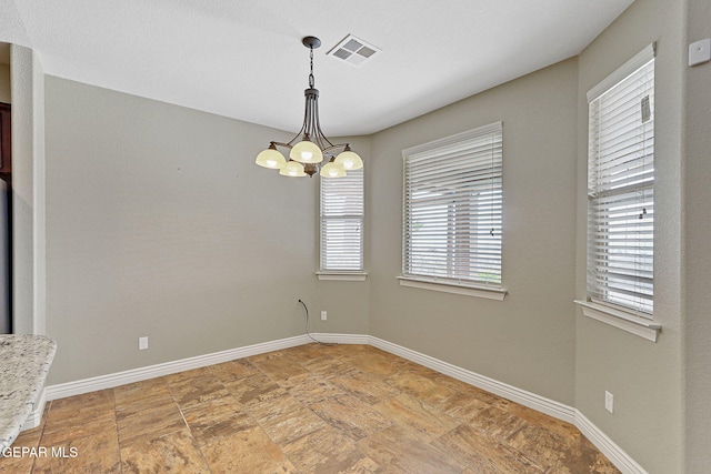737 Colonial Blf, El Paso, TX 79928 - empty room featuring a chandelier, baseboards, and light stone finish flooring