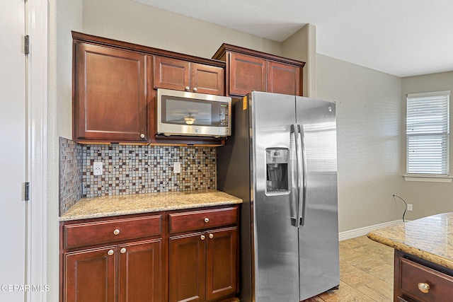 737 Colonial Blf, El Paso, TX 79928 - kitchen with stainless steel appliances, backsplash, baseboards, and light stone countertops