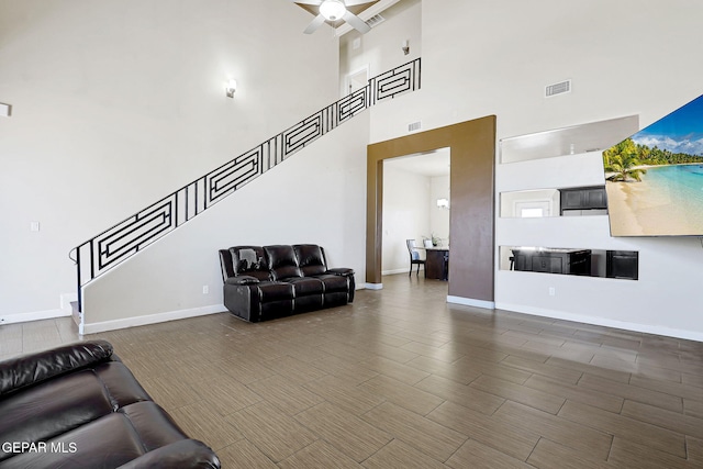 12748 Barstow Ave, El Paso, TX 79928 - living area featuring stairs, a towering ceiling, a ceiling fan, and baseboards