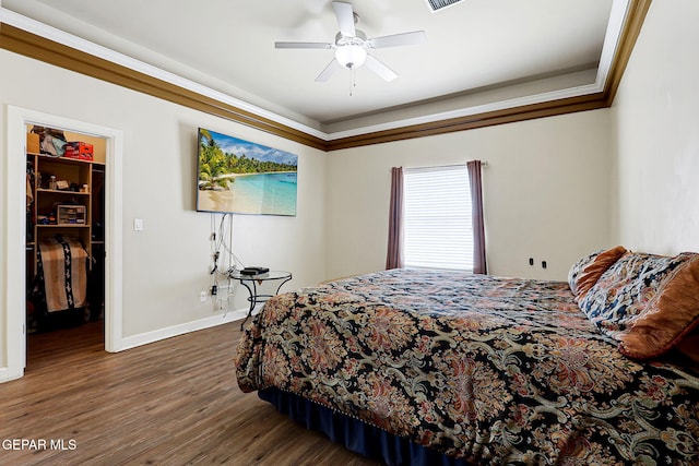 12748 Barstow Ave, El Paso, TX 79928 - bedroom with a walk in closet, baseboards, dark wood-style floors, and a ceiling fan