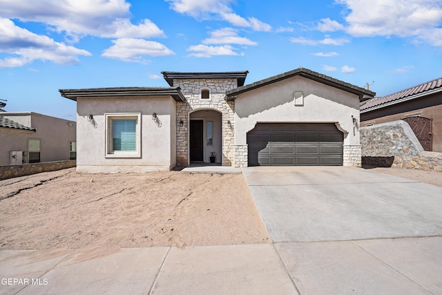 view of front of home featuring stone siding, a garage, stucco siding, and concrete driveway