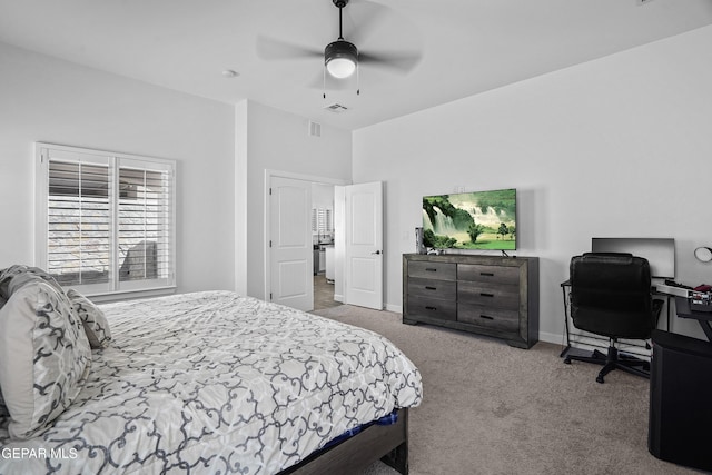 carpeted bedroom with ceiling fan, baseboards, and a desk