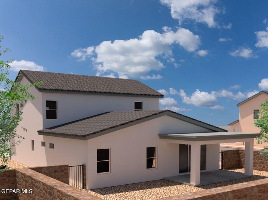 back of house with a patio, stucco siding, and a tile roof