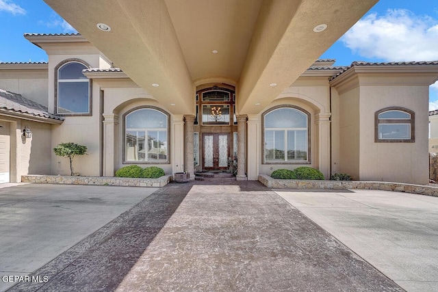 6664 Tuscany Ridge Dr, El Paso, TX 79912 - property entrance featuring a tiled roof and stucco siding