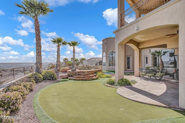 6664 Tuscany Ridge Dr, El Paso, TX 79912 - view of yard with a putting area, a patio, and a balcony