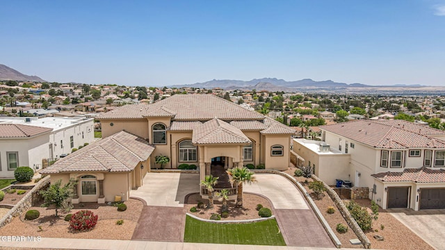 6664 Tuscany Ridge Dr, El Paso, TX 79912 - mediterranean / spanish-style house featuring stucco siding, driveway, a mountain view, and a tiled roof