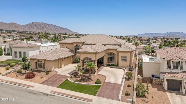 6664 Tuscany Ridge Dr, El Paso, TX 79912 - mediterranean / spanish-style home featuring driveway, a residential view, a mountain view, stucco siding, and a tile roof