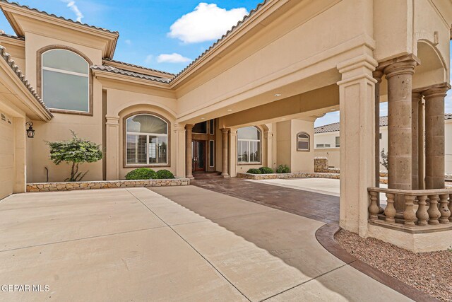 6664 Tuscany Ridge Dr, El Paso, TX 79912 - property entrance featuring a tiled roof and stucco siding