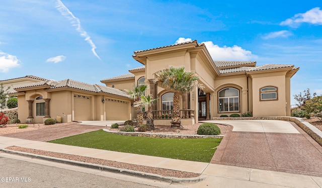 6664 Tuscany Ridge Dr, El Paso, TX 79912 - mediterranean / spanish house with concrete driveway, an attached garage, stucco siding, and a tile roof
