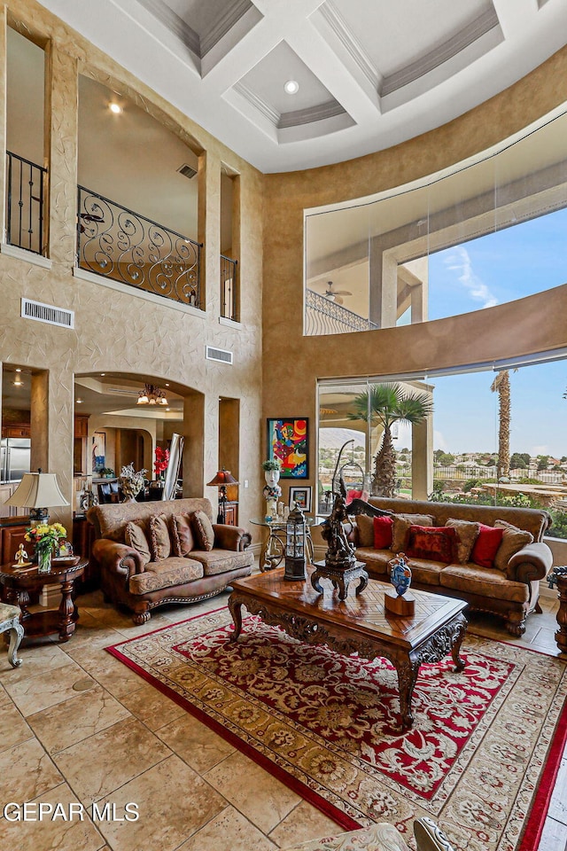 6664 Tuscany Ridge Dr, El Paso, TX 79912 - living room with a high ceiling, coffered ceiling, crown molding, beam ceiling, and a chandelier
