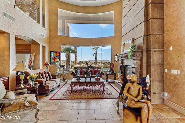 6664 Tuscany Ridge Dr, El Paso, TX 79912 - living room with a towering ceiling and a glass covered fireplace