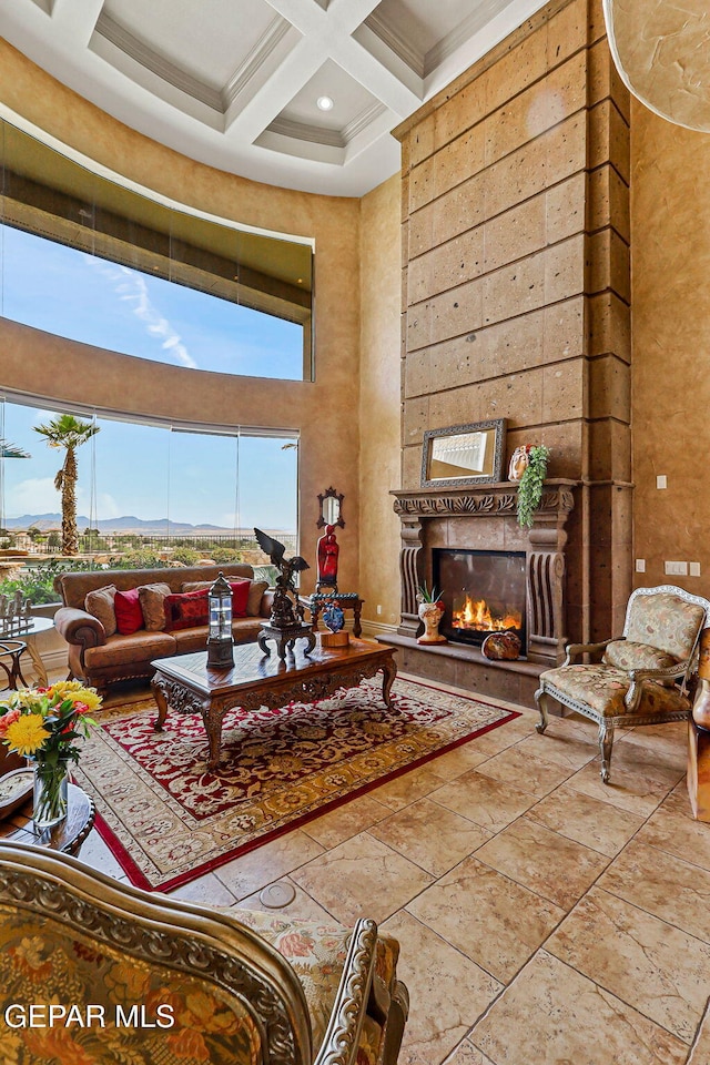 6664 Tuscany Ridge Dr, El Paso, TX 79912 - living area with a high ceiling, coffered ceiling, beam ceiling, and a warm lit fireplace
