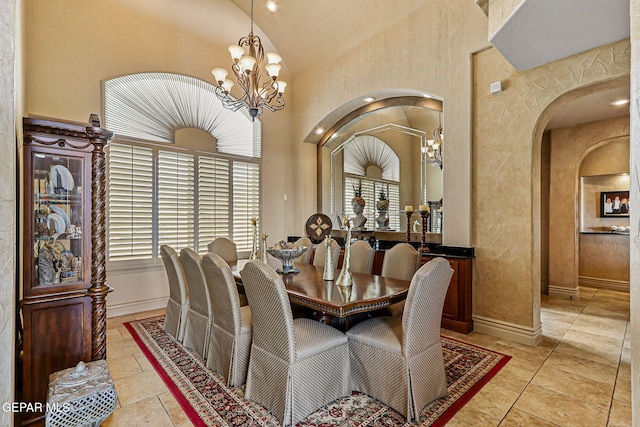 6664 Tuscany Ridge Dr, El Paso, TX 79912 - dining space with a chandelier, arched walkways, healthy amount of natural light, and lofted ceiling