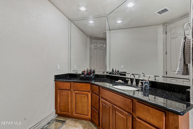 6664 Tuscany Ridge Dr, El Paso, TX 79912 - bathroom featuring vanity, recessed lighting, baseboards, and a textured wall