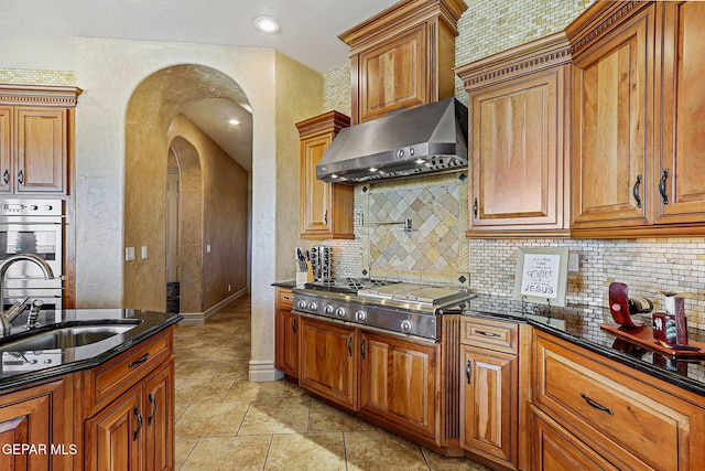 6664 Tuscany Ridge Dr, El Paso, TX 79912 - kitchen featuring under cabinet range hood, stainless steel appliances, decorative backsplash, and a sink