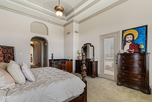 6664 Tuscany Ridge Dr, El Paso, TX 79912 - bedroom with crown molding, light carpet, arched walkways, a towering ceiling, and access to outside