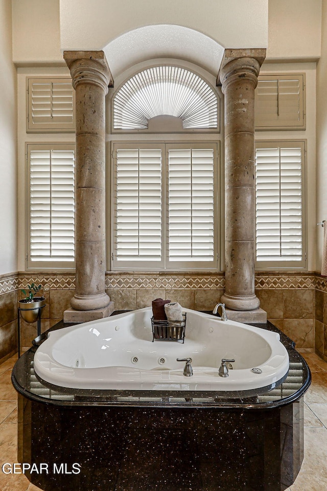 6664 Tuscany Ridge Dr, El Paso, TX 79912 - full bath featuring decorative columns, a jetted tub, and healthy amount of natural light