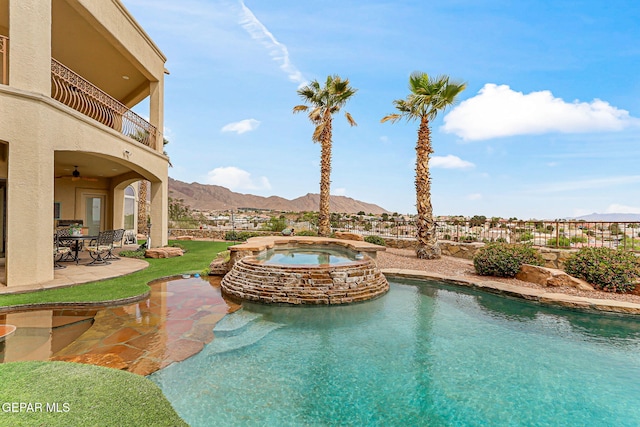 6664 Tuscany Ridge Dr, El Paso, TX 79912 - view of swimming pool with a mountain view, a patio area, ceiling fan, and a pool with connected hot tub