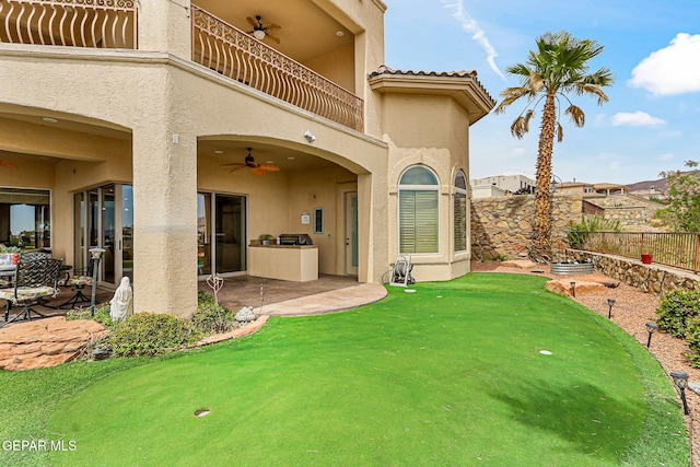 6664 Tuscany Ridge Dr, El Paso, TX 79912 - fenced backyard with a balcony, a putting area, ceiling fan, and a patio area