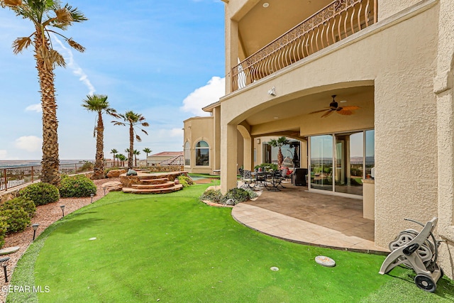 6664 Tuscany Ridge Dr, El Paso, TX 79912 - fenced backyard featuring an area to practice putting, ceiling fan, a balcony, and a patio