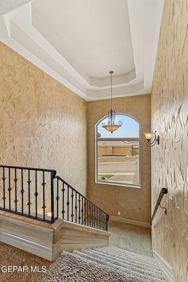 6664 Tuscany Ridge Dr, El Paso, TX 79912 - stairs with carpet flooring, baseboards, and a tray ceiling