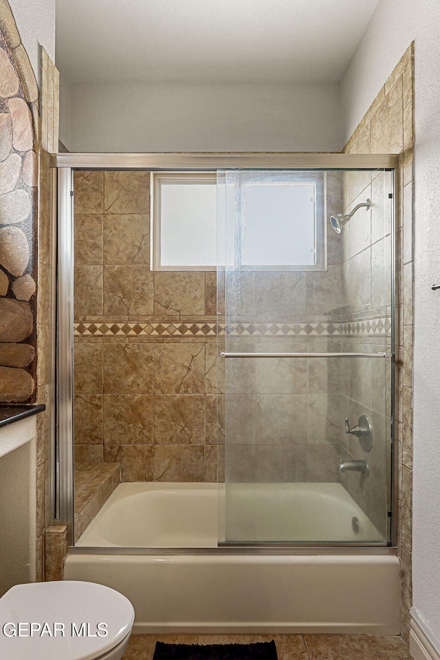 6664 Tuscany Ridge Dr, El Paso, TX 79912 - bathroom featuring toilet, shower / bath combination with glass door, and tile patterned floors