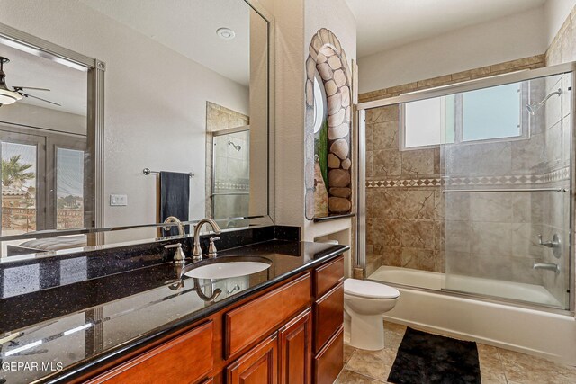 6664 Tuscany Ridge Dr, El Paso, TX 79912 - bathroom featuring vanity, toilet, shower / bath combination with glass door, and ceiling fan