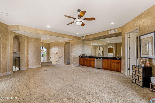6664 Tuscany Ridge Dr, El Paso, TX 79912 - unfurnished living room with arched walkways, ceiling fan, light carpet, recessed lighting, and a sink