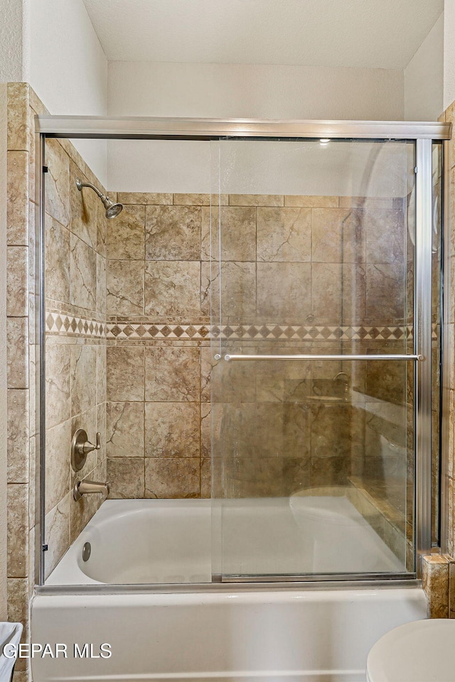 6664 Tuscany Ridge Dr, El Paso, TX 79912 - full bathroom featuring shower / bath combination with glass door and toilet
