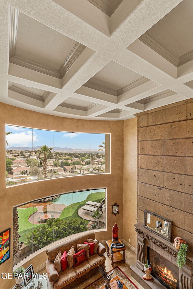 6664 Tuscany Ridge Dr, El Paso, TX 79912 - living room featuring healthy amount of natural light, coffered ceiling, a glass covered fireplace, and beam ceiling