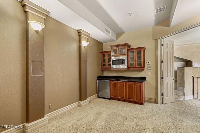 6664 Tuscany Ridge Dr, El Paso, TX 79912 - bar featuring stainless steel appliances, light colored carpet, and baseboards
