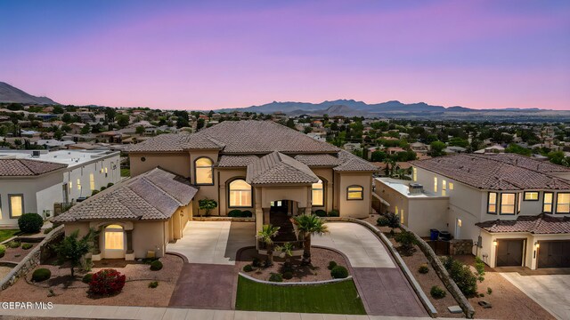 6664 Tuscany Ridge Dr, El Paso, TX 79912 - mediterranean / spanish home featuring concrete driveway, stucco siding, a mountain view, and a tiled roof