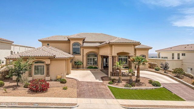 6664 Tuscany Ridge Dr, El Paso, TX 79912 - mediterranean / spanish home with stucco siding, a tiled roof, and curved driveway