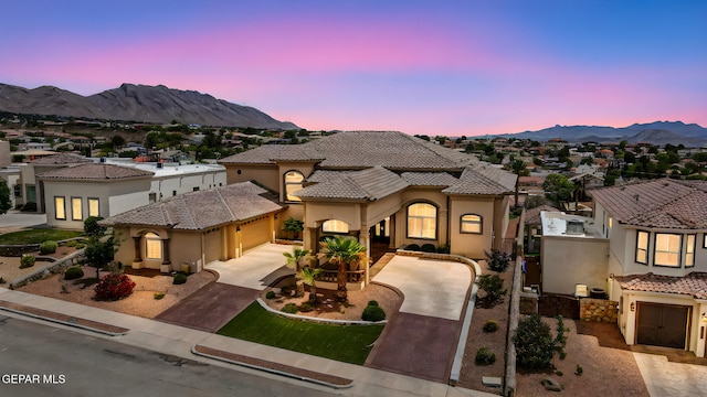 6664 Tuscany Ridge Dr, El Paso, TX 79912 - mediterranean / spanish home featuring concrete driveway, a mountain view, stucco siding, a garage, and a tile roof