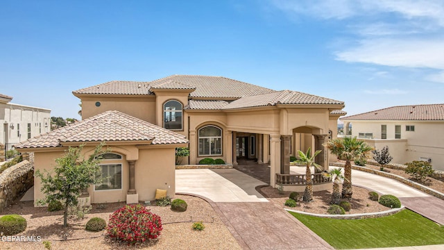 6664 Tuscany Ridge Dr, El Paso, TX 79912 - mediterranean / spanish-style home with stucco siding, a tile roof, and concrete driveway