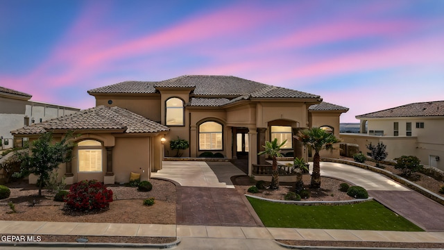 6664 Tuscany Ridge Dr, El Paso, TX 79912 - mediterranean / spanish home featuring curved driveway, stucco siding, and a tile roof