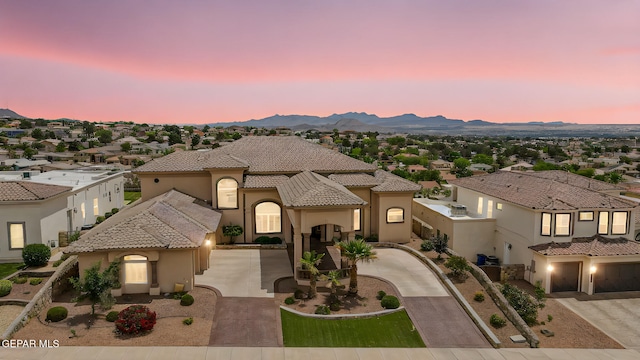 6664 Tuscany Ridge Dr, El Paso, TX 79912 - mediterranean / spanish house with curved driveway, stucco siding, a tile roof, a mountain view, and a residential view