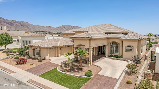 6664 Tuscany Ridge Dr, El Paso, TX 79912 - mediterranean / spanish-style home with stucco siding, a tiled roof, concrete driveway, and a garage