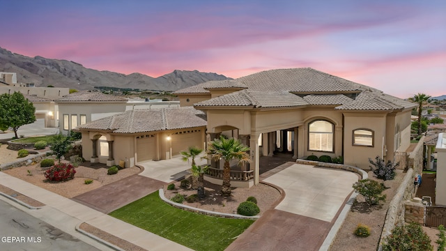 6664 Tuscany Ridge Dr, El Paso, TX 79912 - mediterranean / spanish house with a garage, stucco siding, driveway, and a mountain view