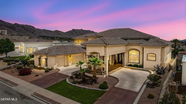 6664 Tuscany Ridge Dr, El Paso, TX 79912 - mediterranean / spanish home featuring driveway, stucco siding, a garage, a mountain view, and a tile roof