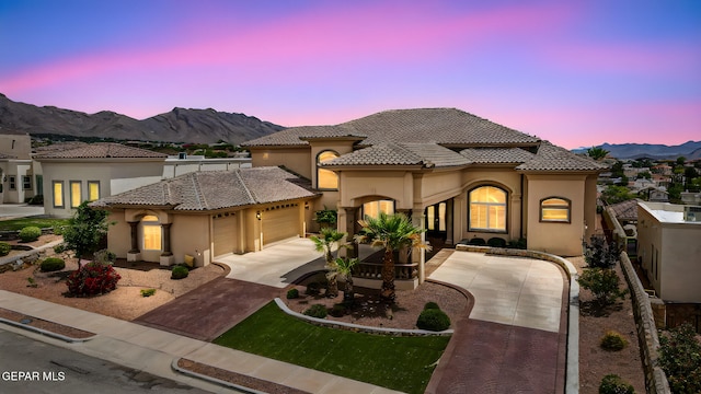 6664 Tuscany Ridge Dr, El Paso, TX 79912 - mediterranean / spanish-style home with an attached garage, stucco siding, a mountain view, and a tile roof