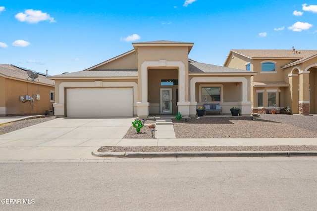 14328 N Cave Dr, El Paso, TX 79938 - view of front of house featuring a garage, stucco siding, and driveway
