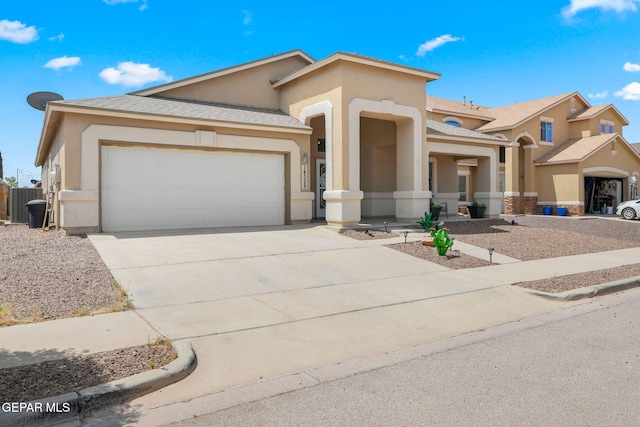 14328 N Cave Dr, El Paso, TX 79938 - view of front of house featuring an attached garage, stucco siding, and concrete driveway