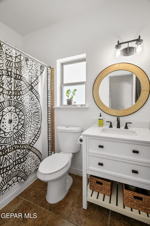 14328 N Cave Dr, El Paso, TX 79938 - bathroom with toilet, vanity, baseboards, and curtained shower